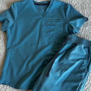 Fabletics scrubs size small (pants are small short). Color is wave blue